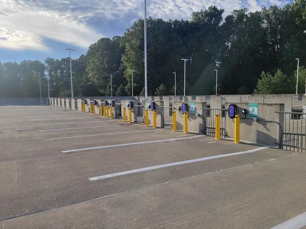 a row of electric vehicle charging stations in a parking garage .