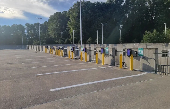a row of electric vehicle charging stations in a parking garage .
