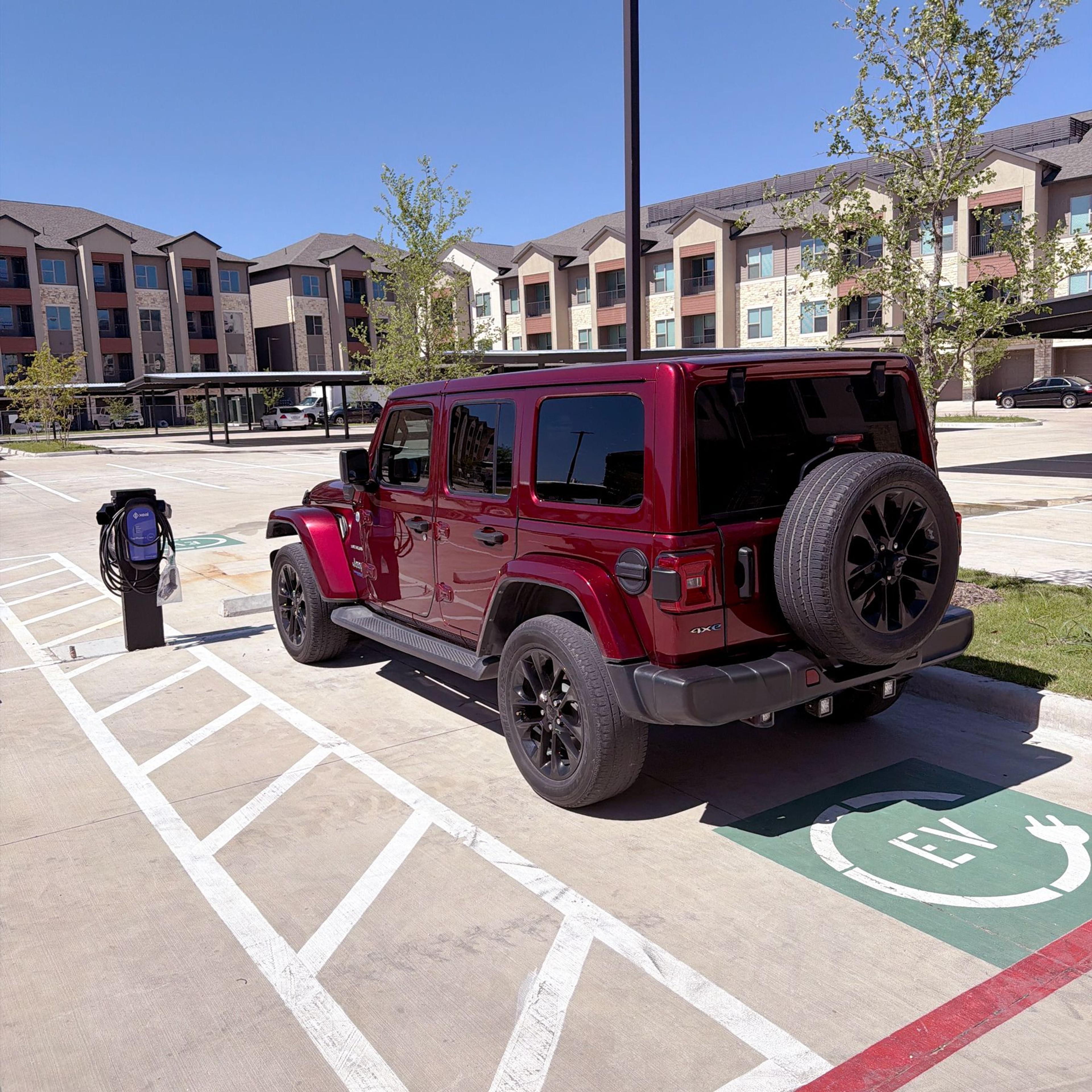 Jeep in parking space next to xeal charger