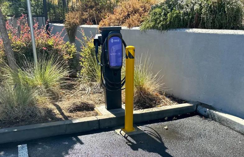 an electric vehicle charging station in a parking lot .