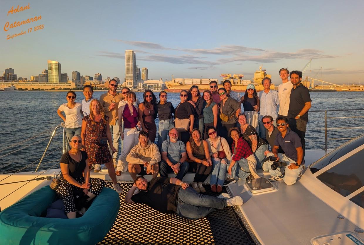 Group Photo of Radicle Science team on a boat with skyline in the background