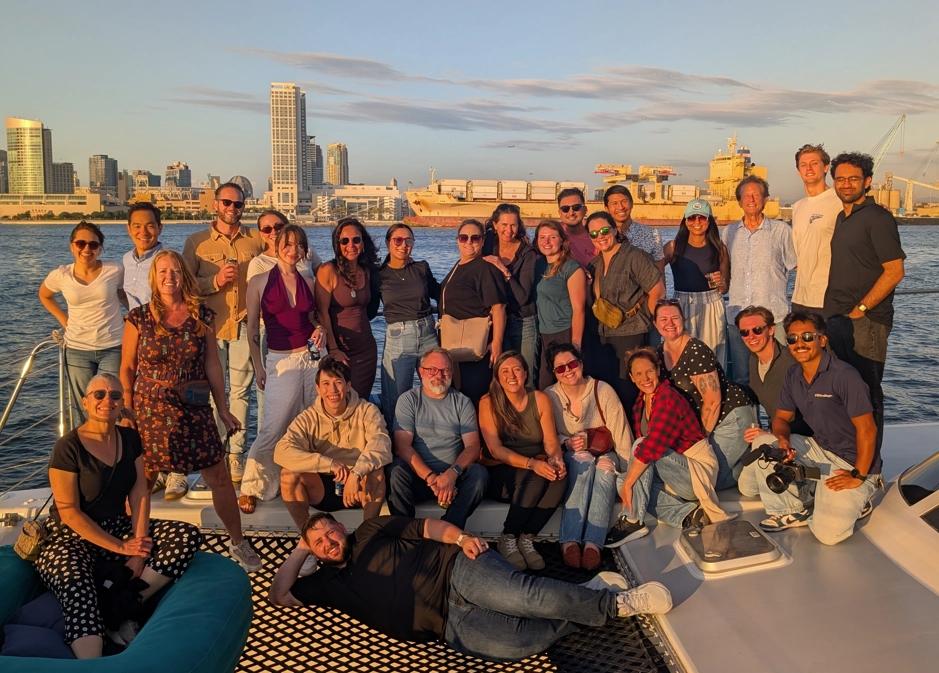 Group Photo of Radicle Science team on a boat with skyline in the background