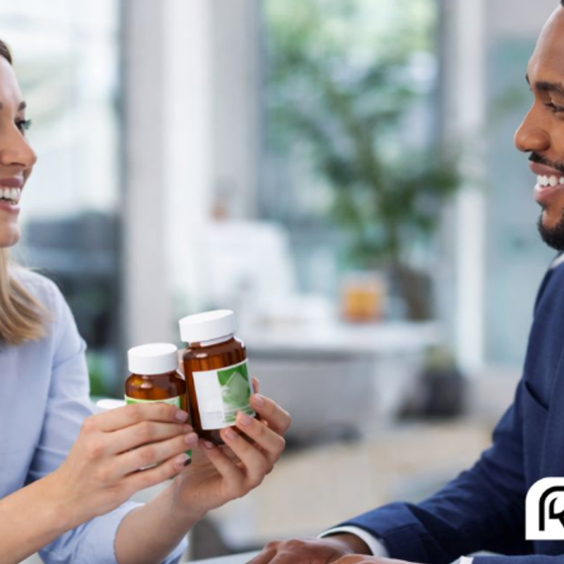 Woman holding two pill bottles showing them to man next to her