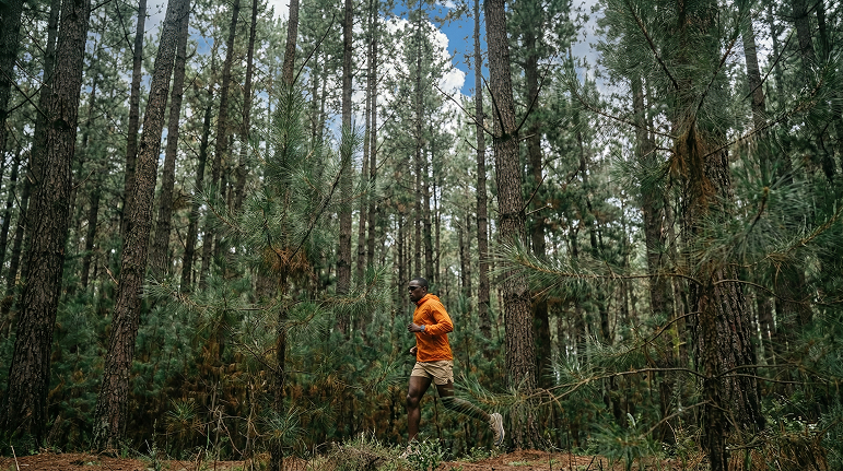 Man trail running in the woods