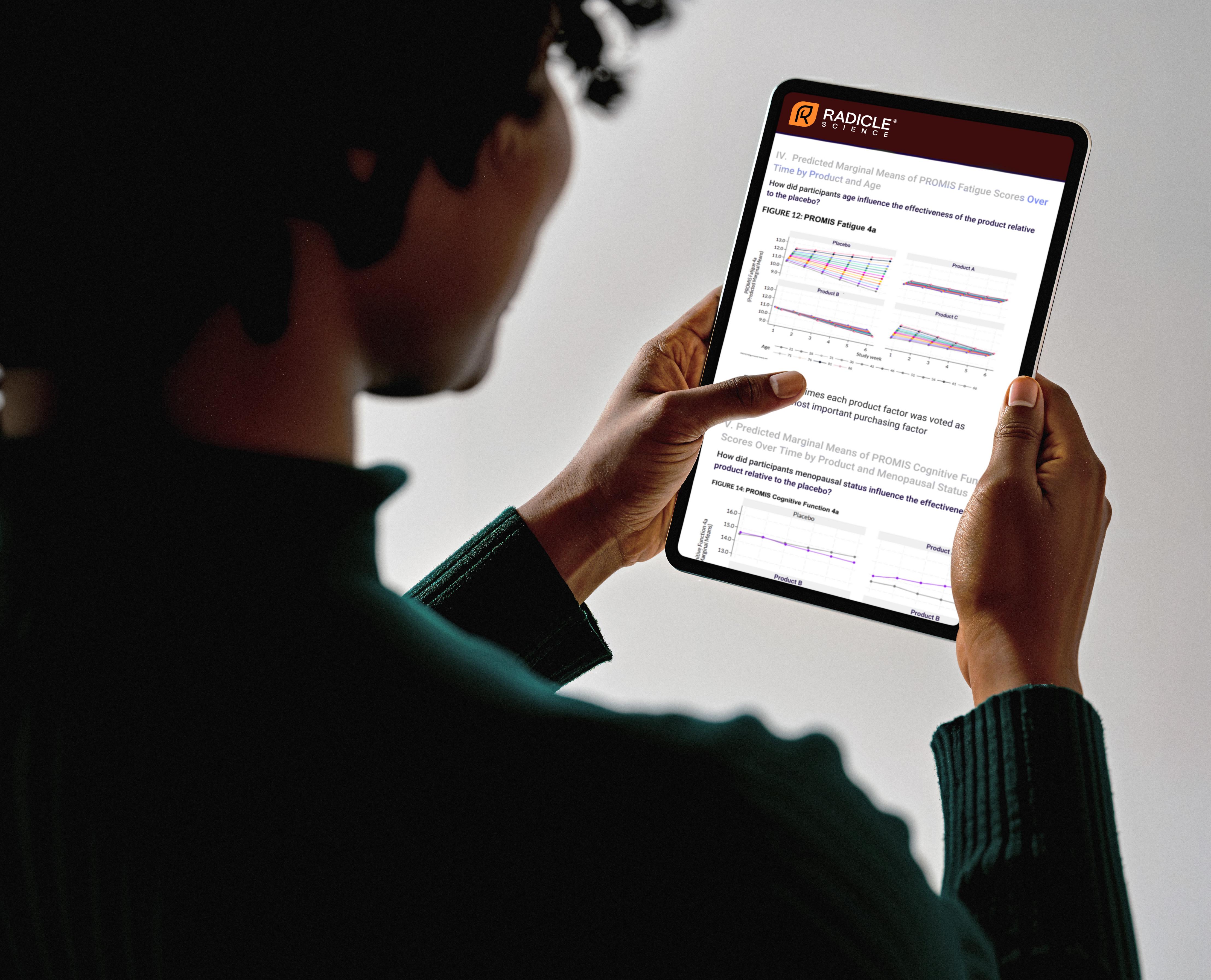 Person holding tablet with data analysis reports