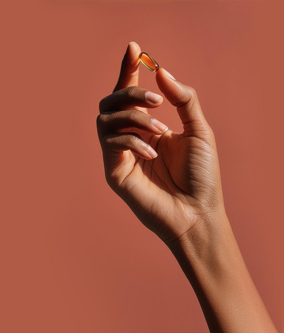 Hand holding translucent supplement pill