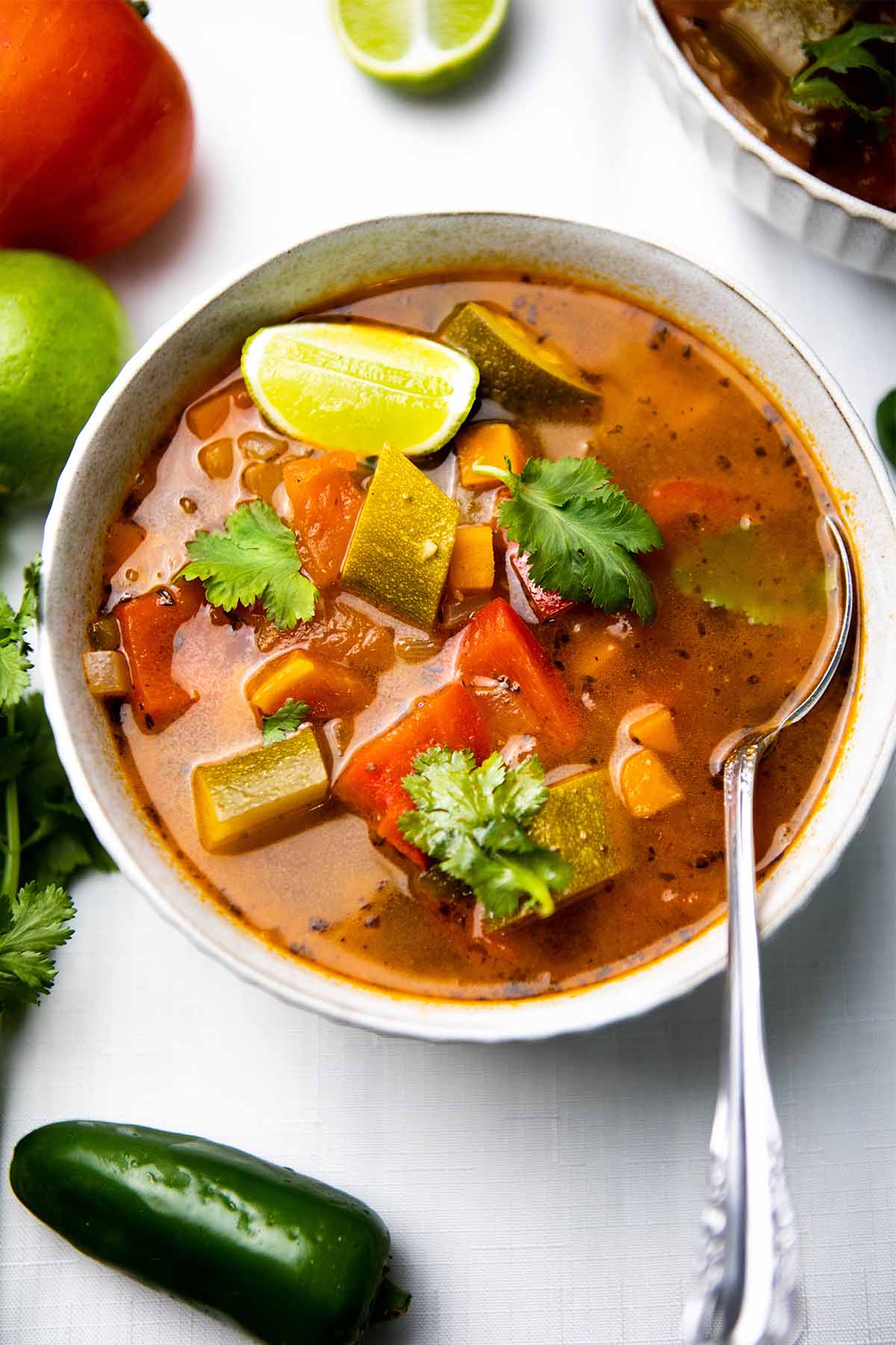 A top-down view of Mexican vegetable soup in a bowl.