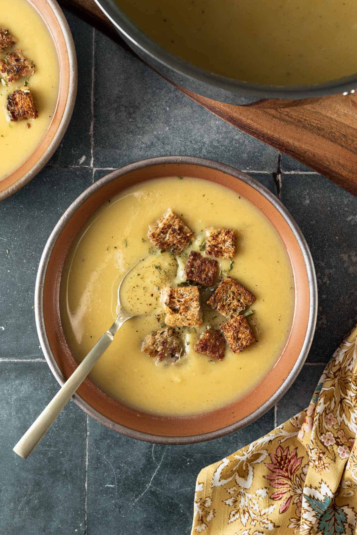 A top-down view of white sweet potato soup in a bowl.