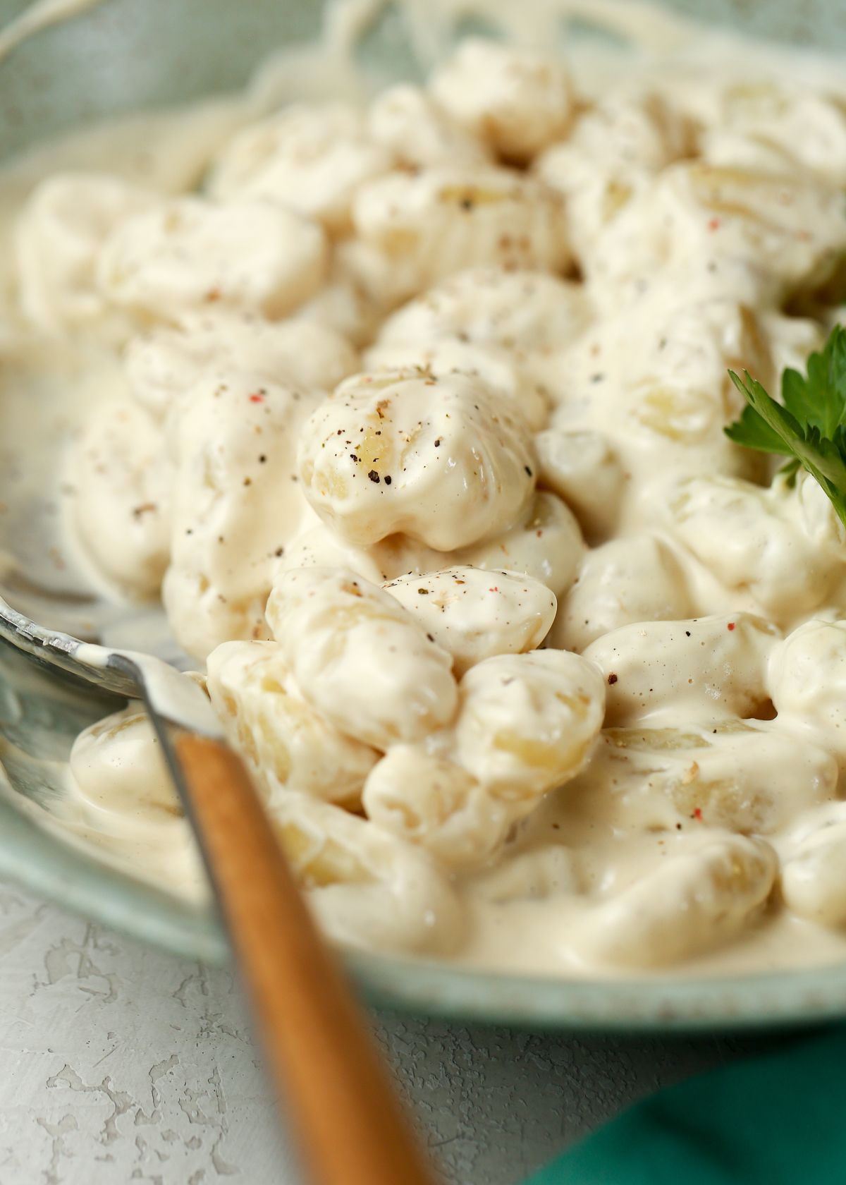 Gnocchi in a bowl, coated in vegan Alfredo sauce. 