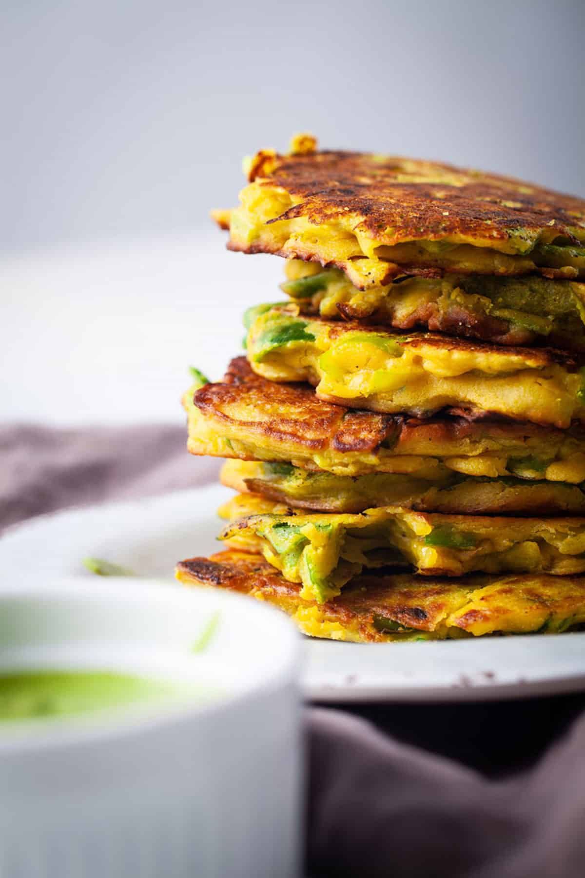 Vegan vegetable cakes, stacked on a plate. 