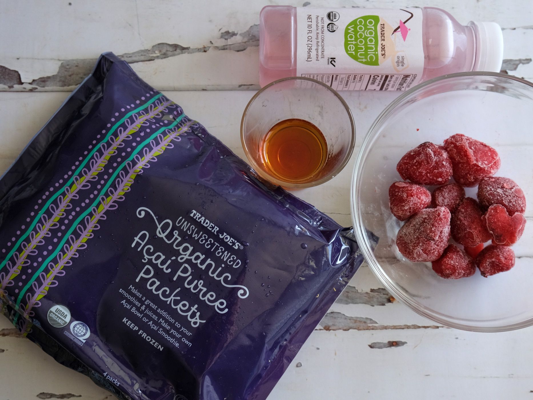 This simple smoothie is made with an açaí packet, frozen strawberries, coconut water, and maple syrup.