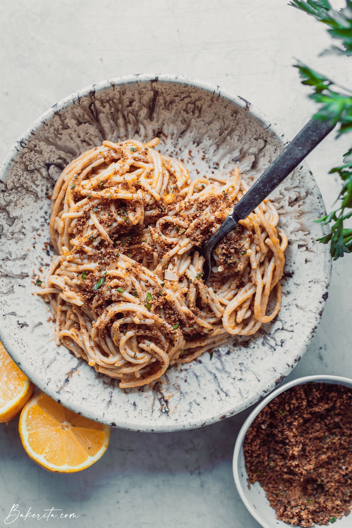 A bowl of creamy lemon pasta topped with toasted breadcrumbs.