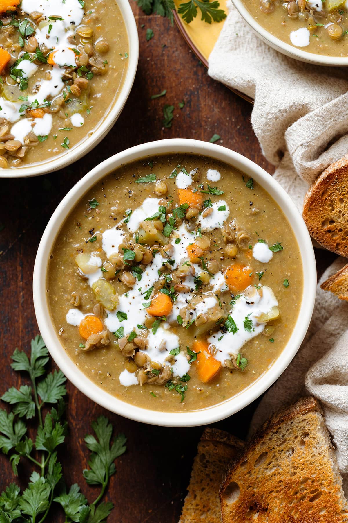 Three bowls of vegan lentil soup.