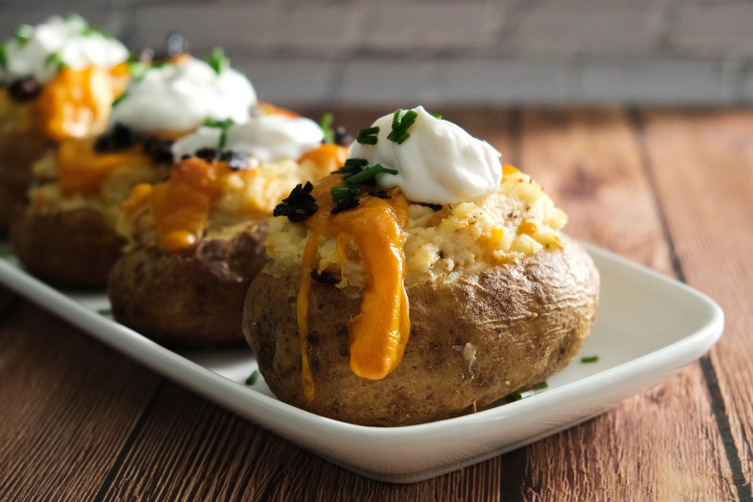Vegan loaded baked potatoes on a platter