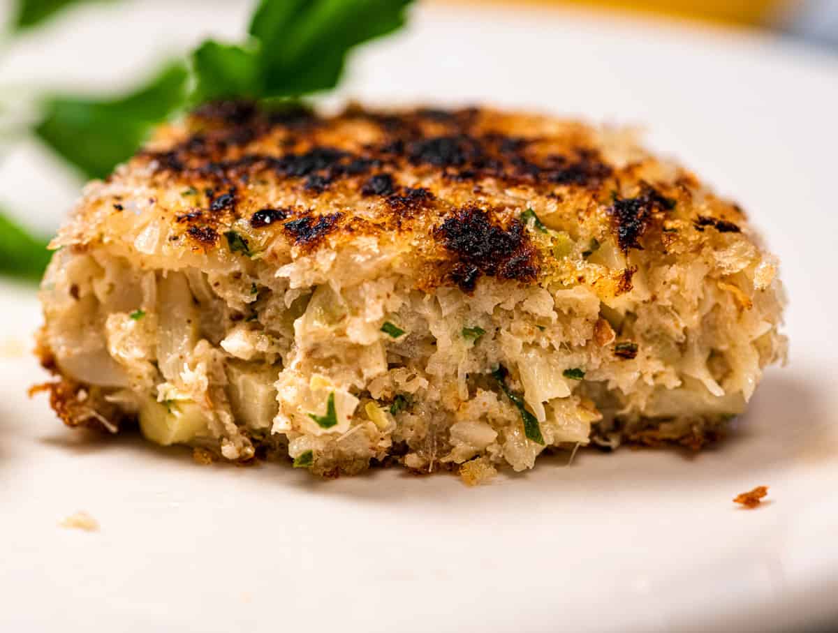 Half of a vegan seafood cake on a plate, showing the inside texture of the cake. 
