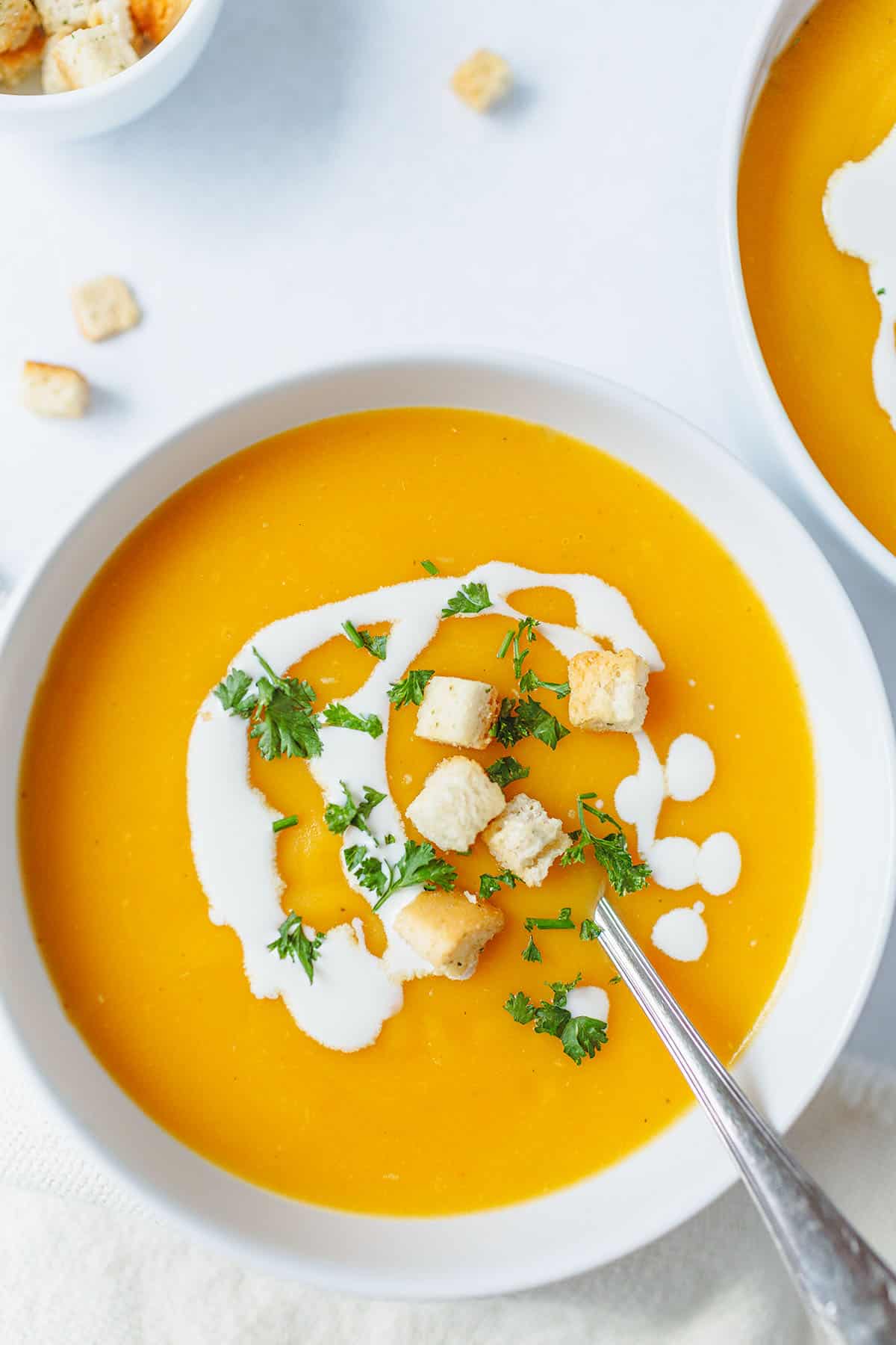 A top-down view of potato carrot soup in a bowl.