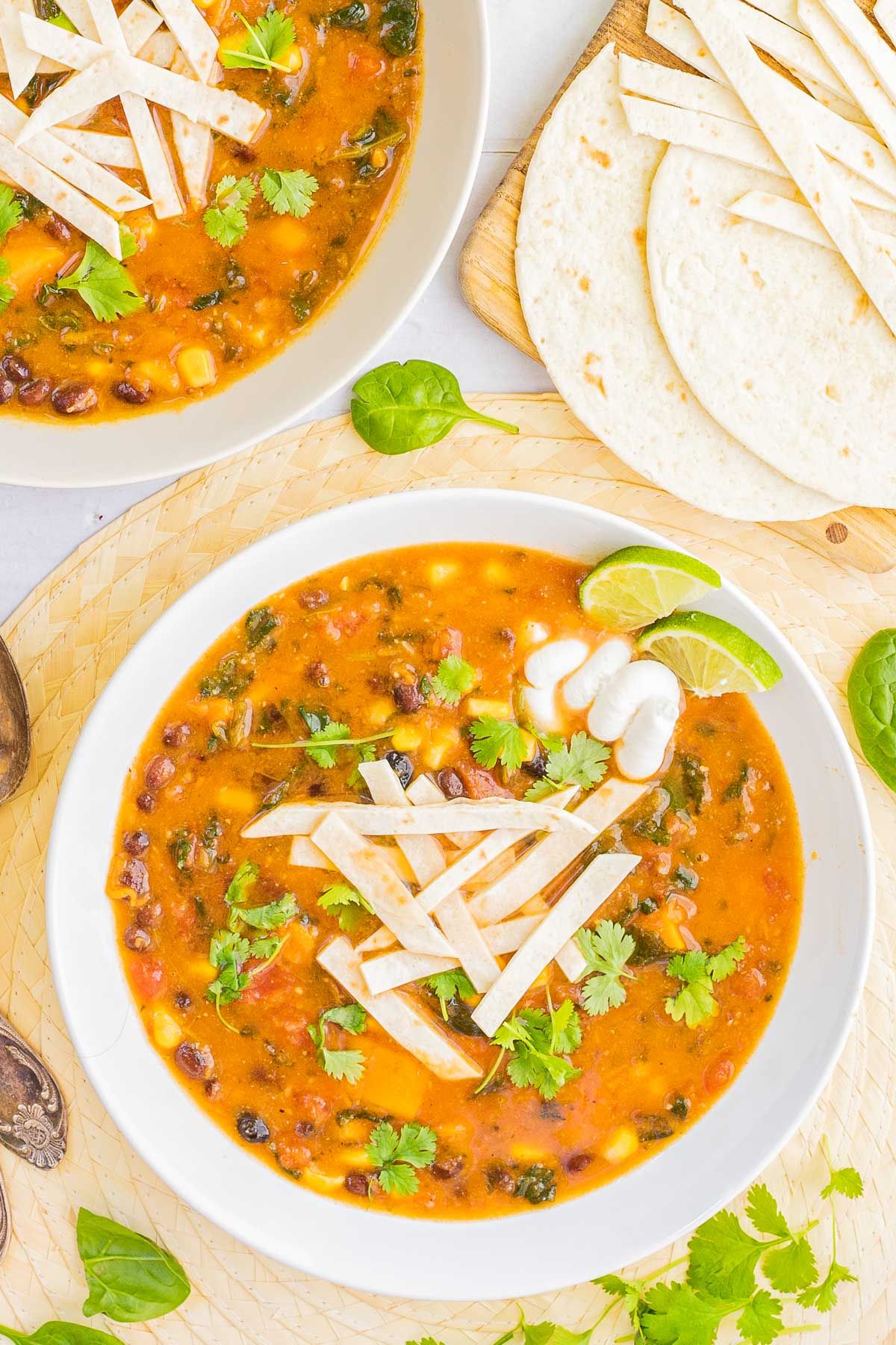 Two bowls of vegan tortilla soup.
