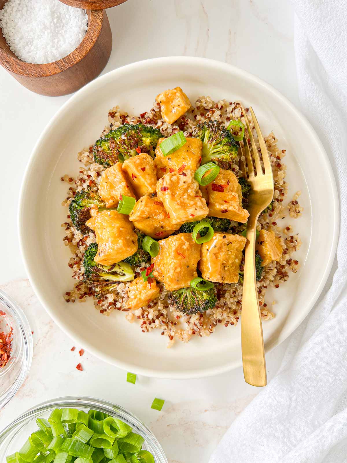 Vegan Honey Mustard Tofu on a plate with quinoa and green onions.