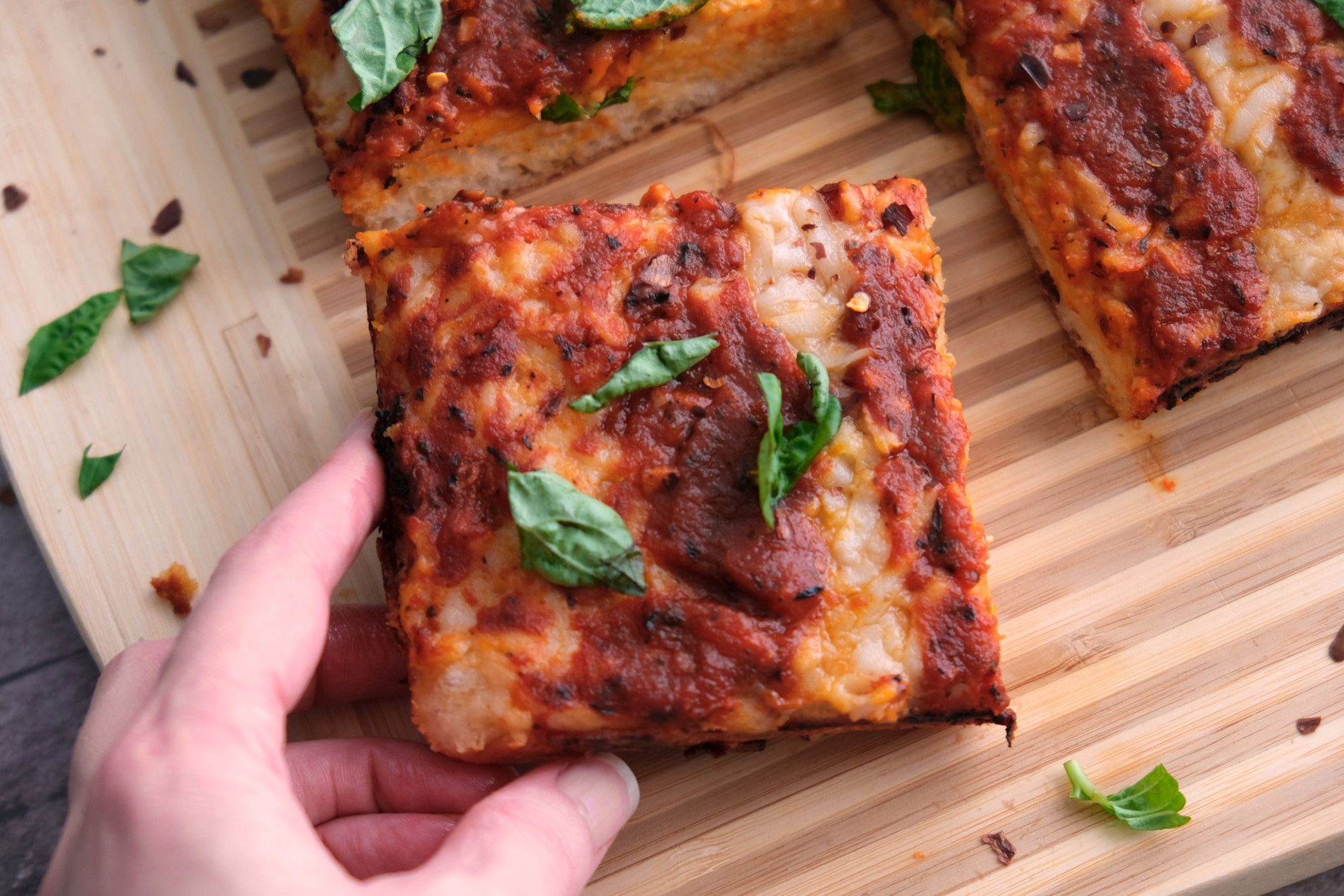 Picking up a slice of pizza