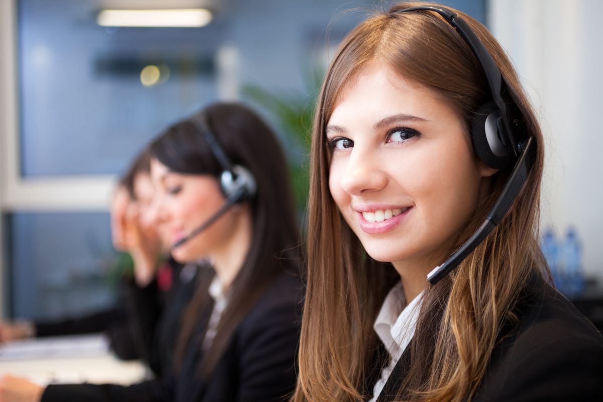 A person with a headset smiling