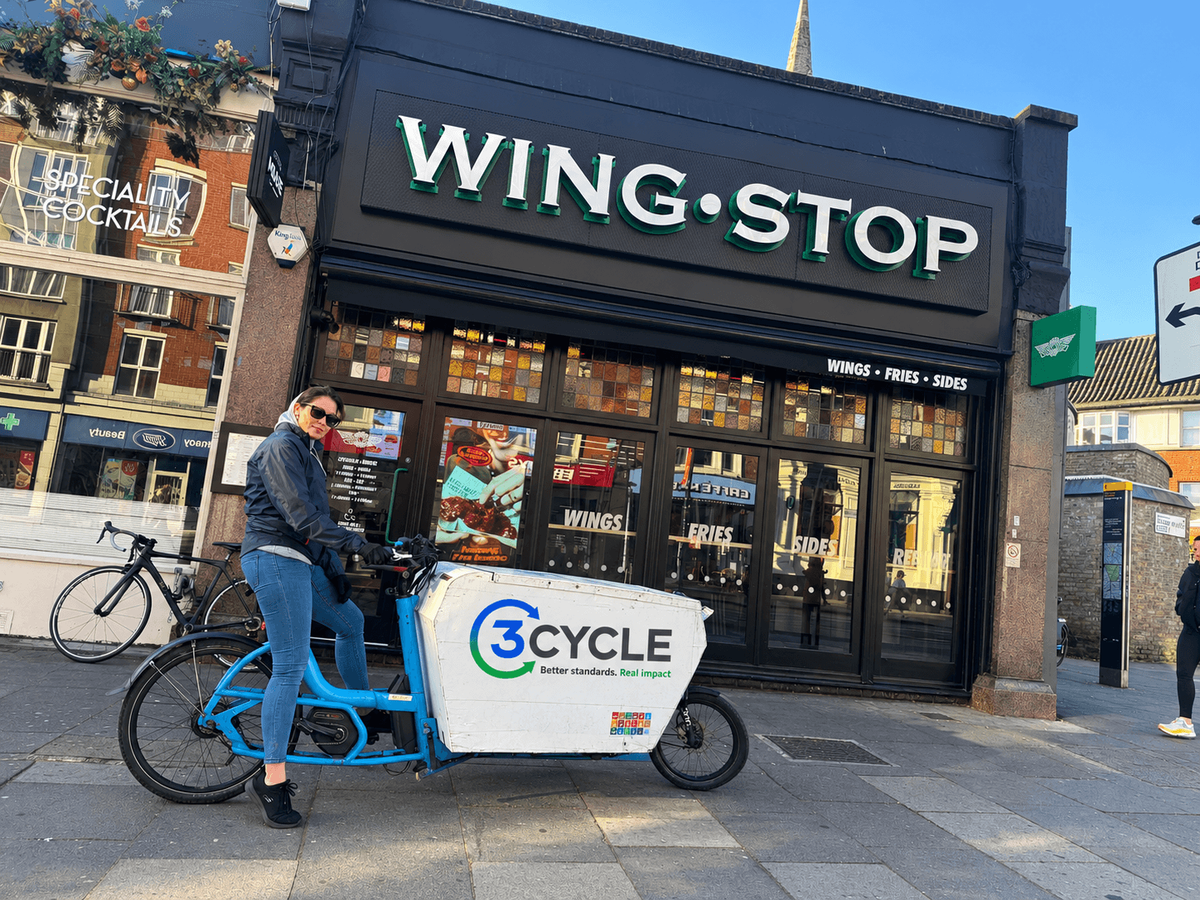 3Cycle rider on a cargo bike outside a Wingstop restaurant in London