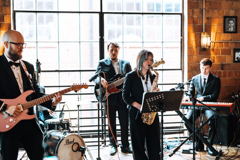Full band playing with saxophone