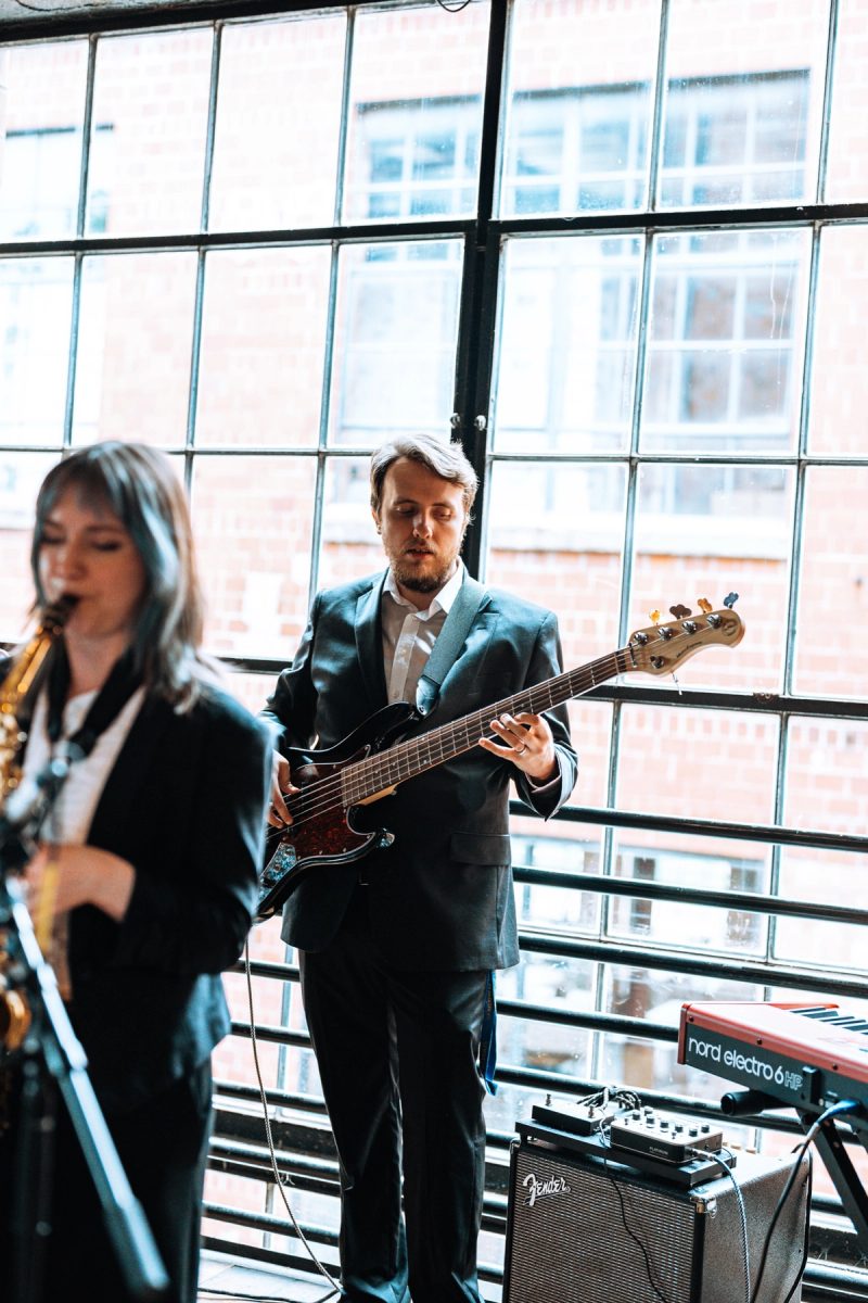 Full band performing with saxophone