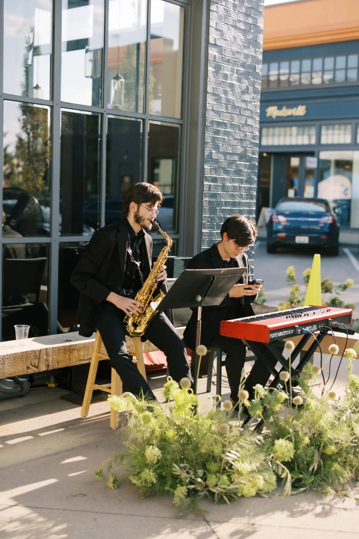 Duo pictured performing at a grand opening Corporate Event for Fiabesca Shoes