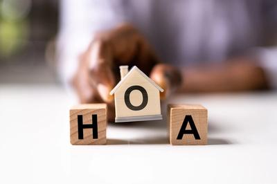 "HOA" lettered blocks shaped as blocks and a house in the center.