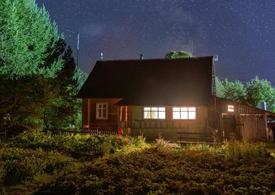 a cottage with a rich garden at night