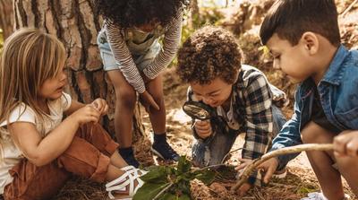 kids looking at a plant