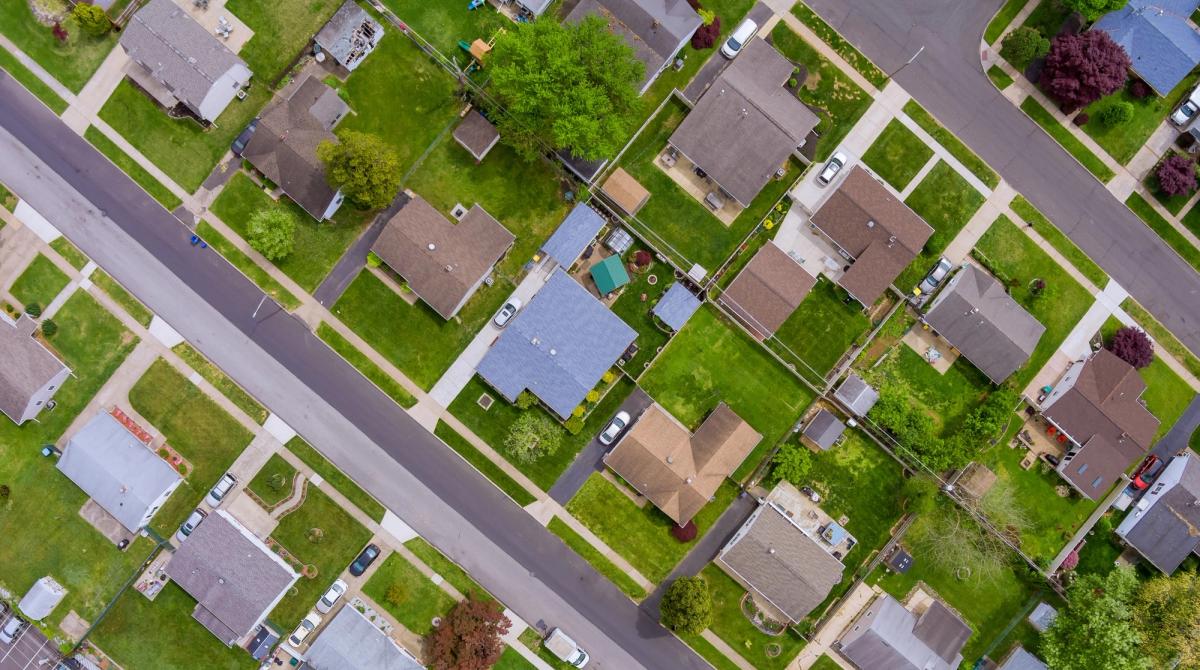 Overhead view of a neighborhood with traditional lawns