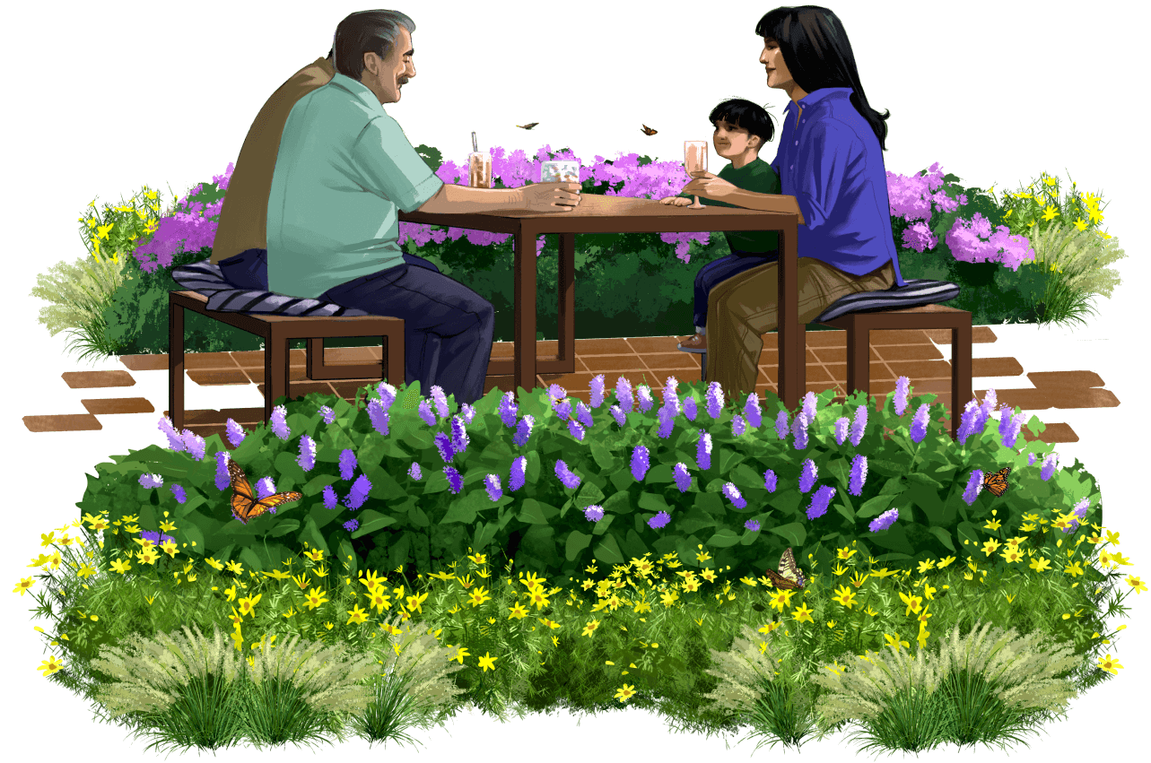 several people sitting at a picnic bench surrounded by plants and flowers