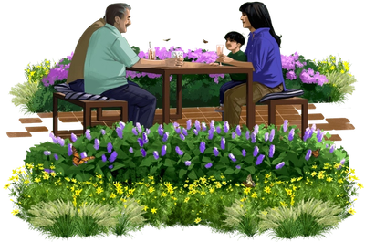 several people sitting at a picnic bench surrounded by plants and flowers