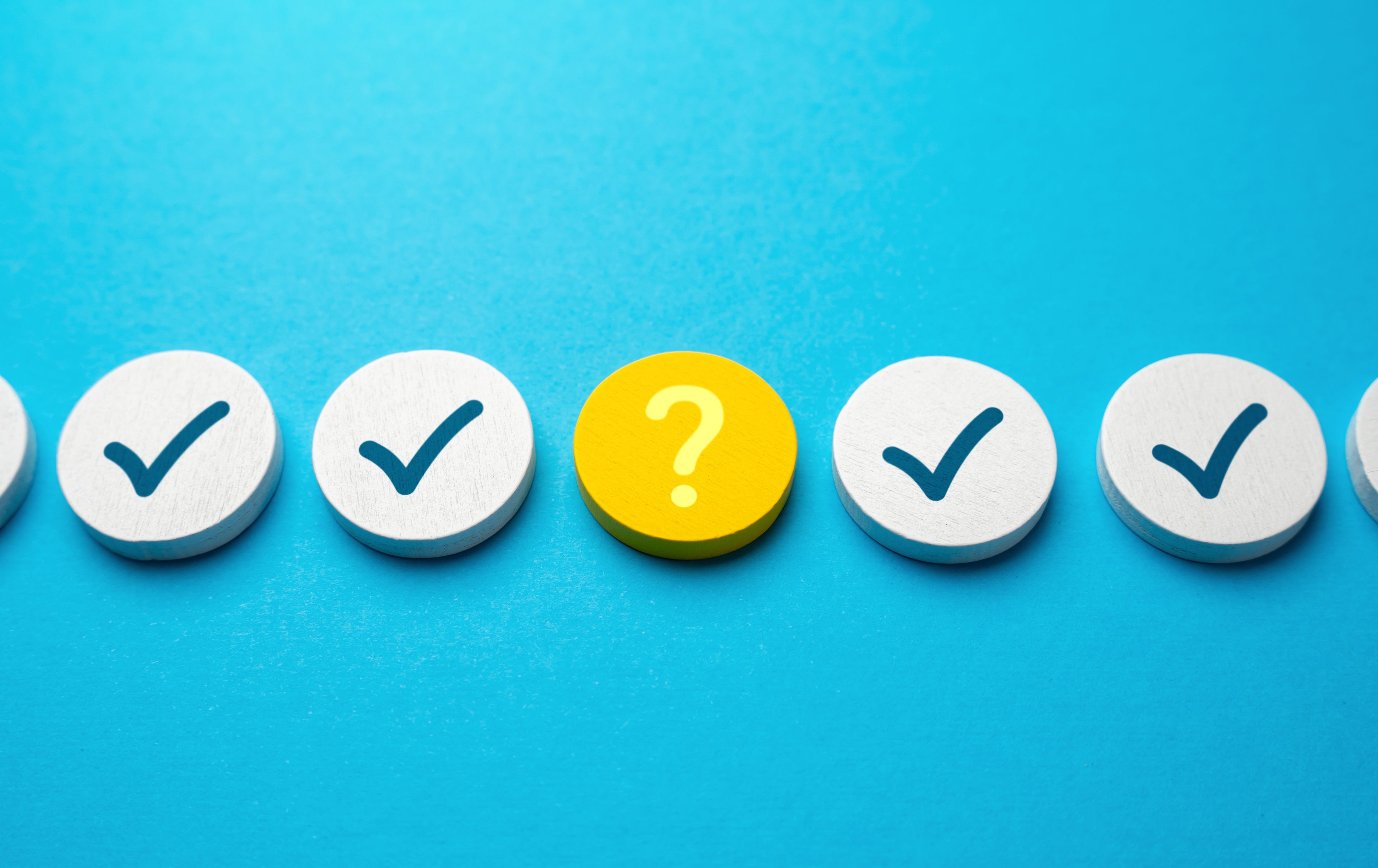 Bright blue background with dots of checkmarks and question marks.