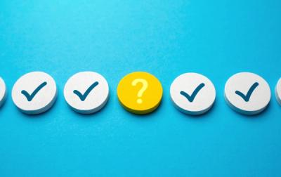 Bright blue background with dots of checkmarks and question marks.