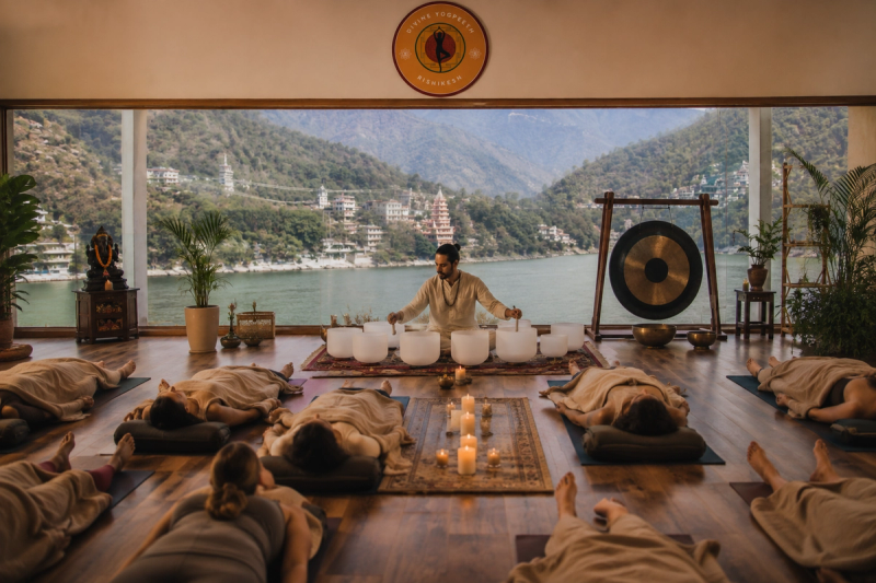 Participants deeply relaxing during a group sound bath session at Divine Yogpeeth.