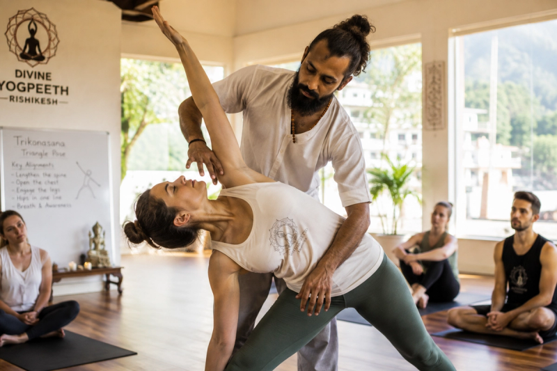 Learning hands-on adjustments for Yoga Alliance RYT 200 certification details in India.