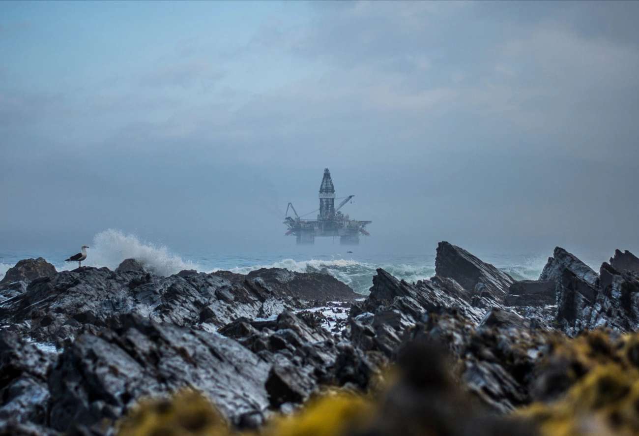 Oil rig in the background with cliffs in the foreground