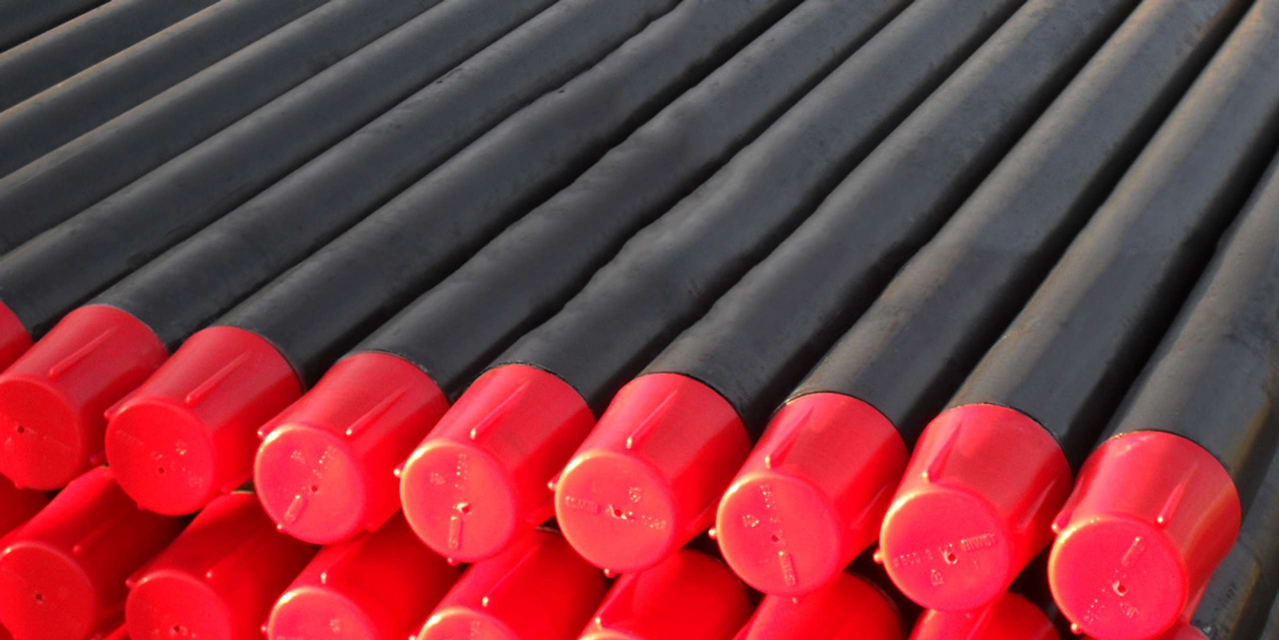 Black tubes with red caps stacked