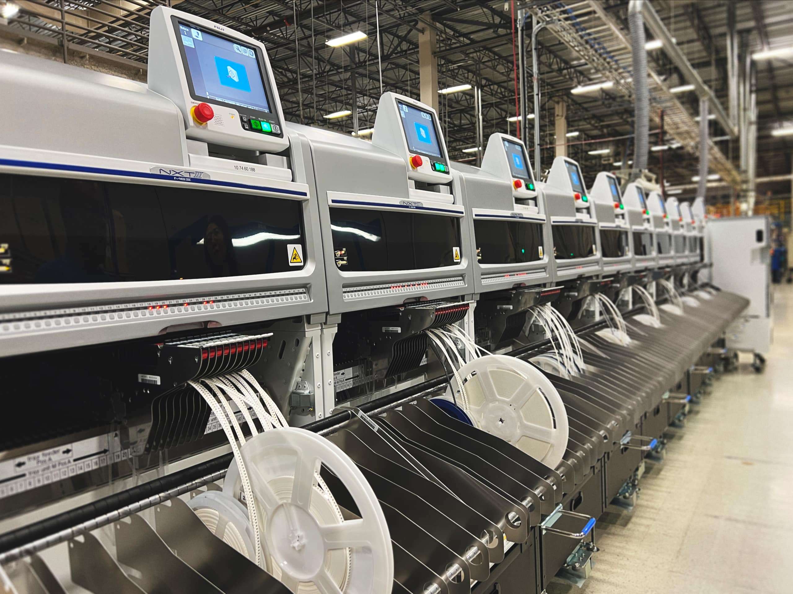 Row of electronic manufacturing machines in a production hall