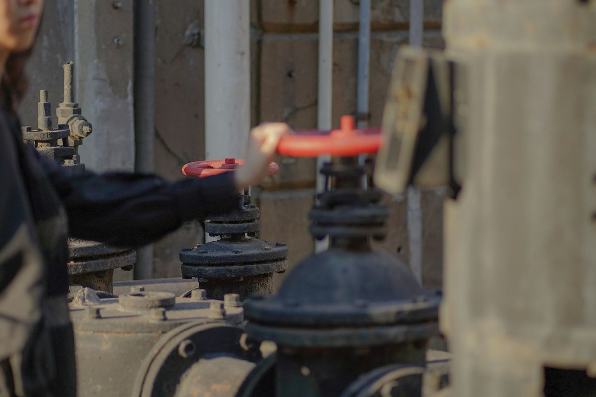 A Gas Safe engineer carrying out an annual boiler safety inspection in a rental flat