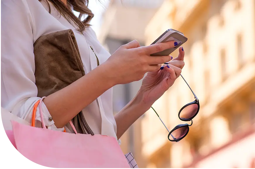 gift card program_woman smiling while handing a bag to a customer
