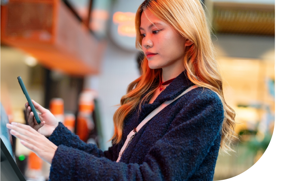 Woman using her phone to pay - Counter Solutions - Shift4