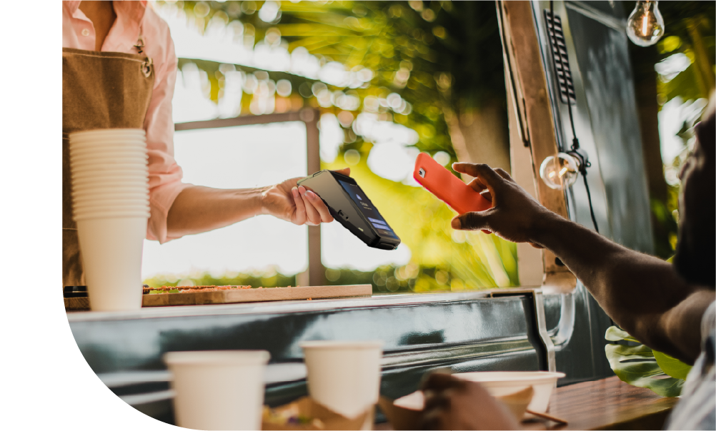 Business owner using SkyTab Solo to accept a contacless payment from a customer | Shift4