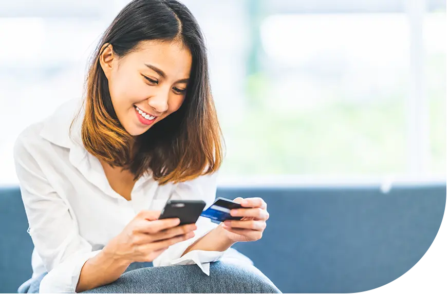 gift card program_woman smiling at phone an credit card