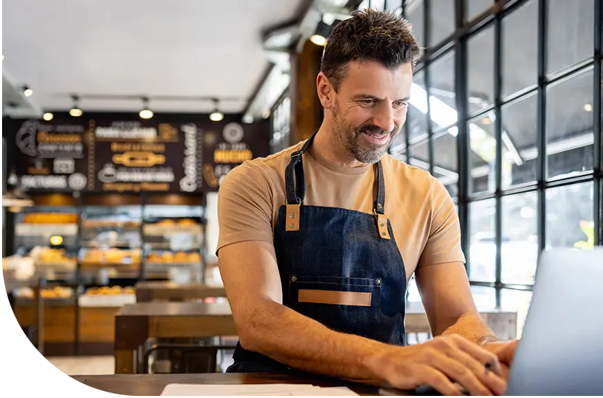 gift card program_man smiling at laptop