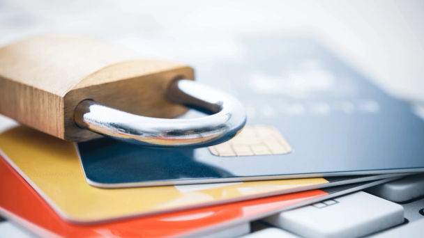 Card security image showing padlock on a pile of credit cards
