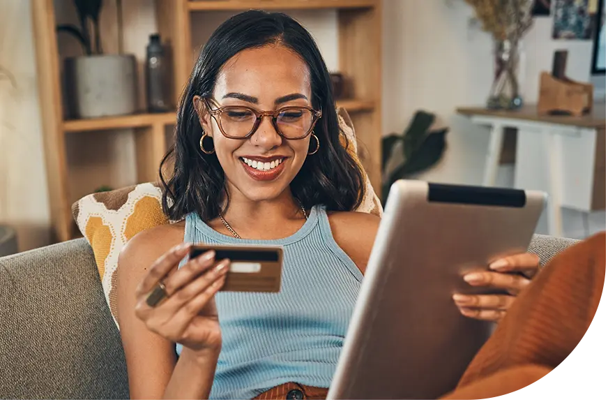 gift card program_woman smiling at tablet and credit card