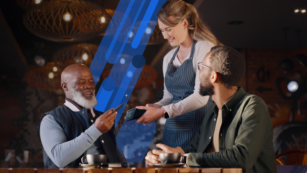 Restaurant customers enjoying the POS experience by making payments on a mobile POS device held by a waitress | Shift4